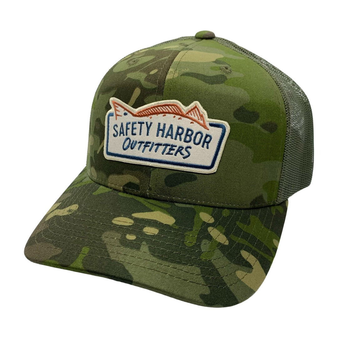 The Jungle hat is a structured trucker hat emblazoned with the Safety Harbor Outfitters logo. This hat is specifically made for anglers in deep cover. For the anglers who go waaayyy back into the various Florida jungles to almost purposely get lost and survive off of fish and the land! Or for anyone else who just likes to wear an awesome hat!